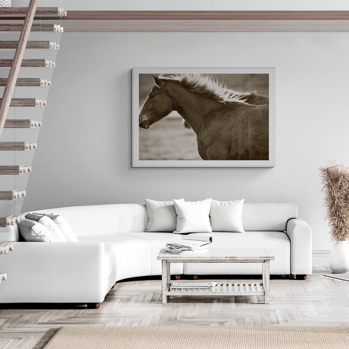Living room with a white sofa, coffee table, and framed horse picture on the wall.