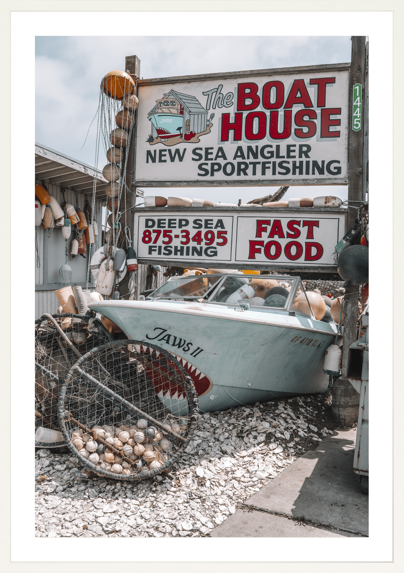 Coastal classic brimming with vintage memorabilia, Boat House, modern fine art print with retro seaside charm. White frame.