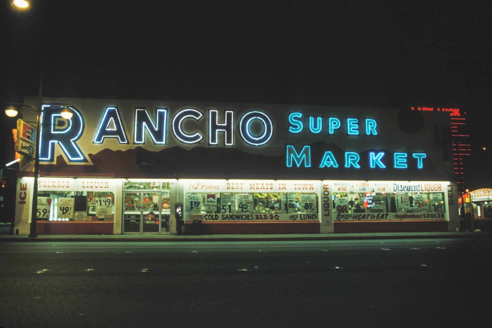Neon sign of Rancho Super Market at night