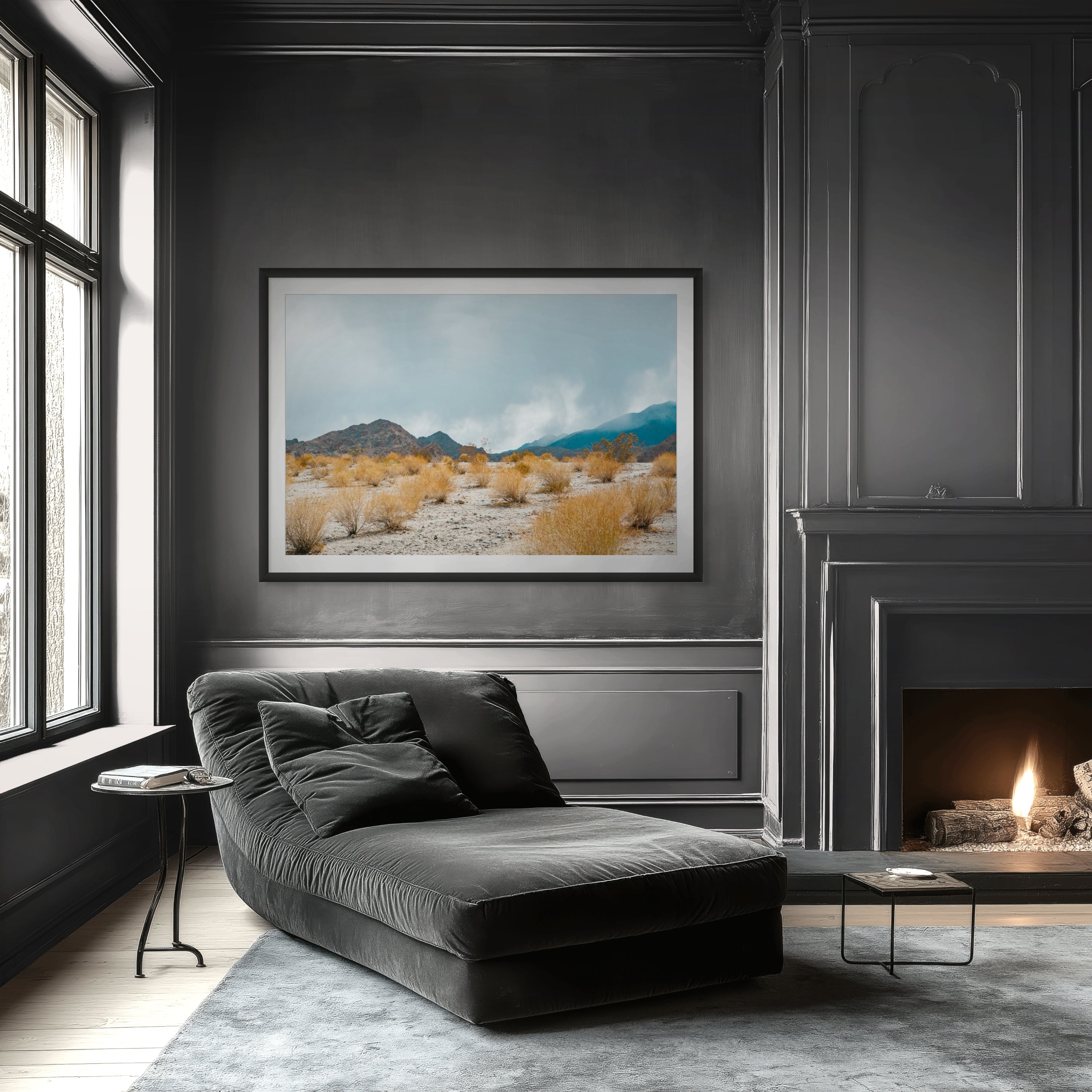 Modern living room with a gray chaise lounge, fireplace, and framed landscape art.