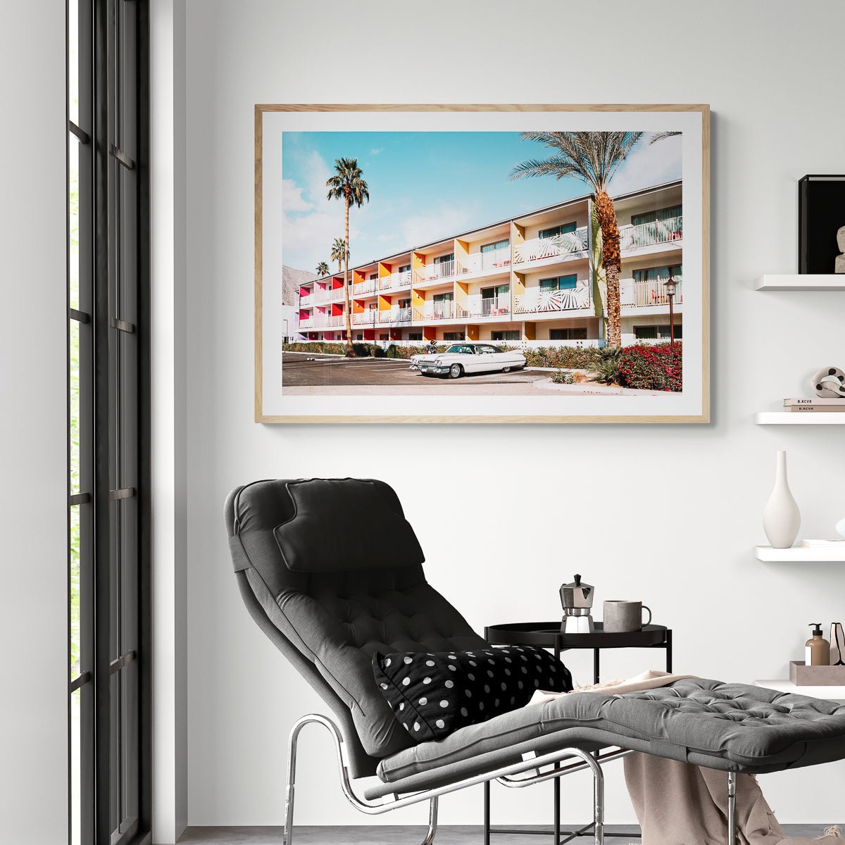 Guitars and Cadillacs, Palm Springs, California fine art print in a natural wood frame above a chaise, by Jules Frazier