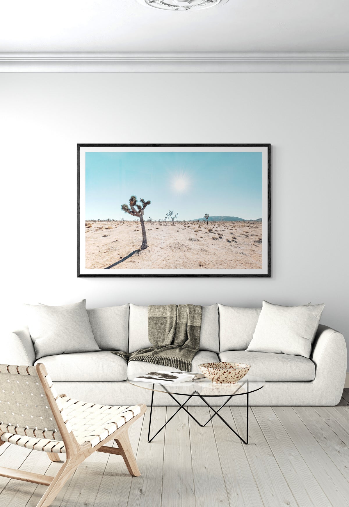 Joshua Tree Sun fine art print in a black frame above a sofa, by Jules Frazier
