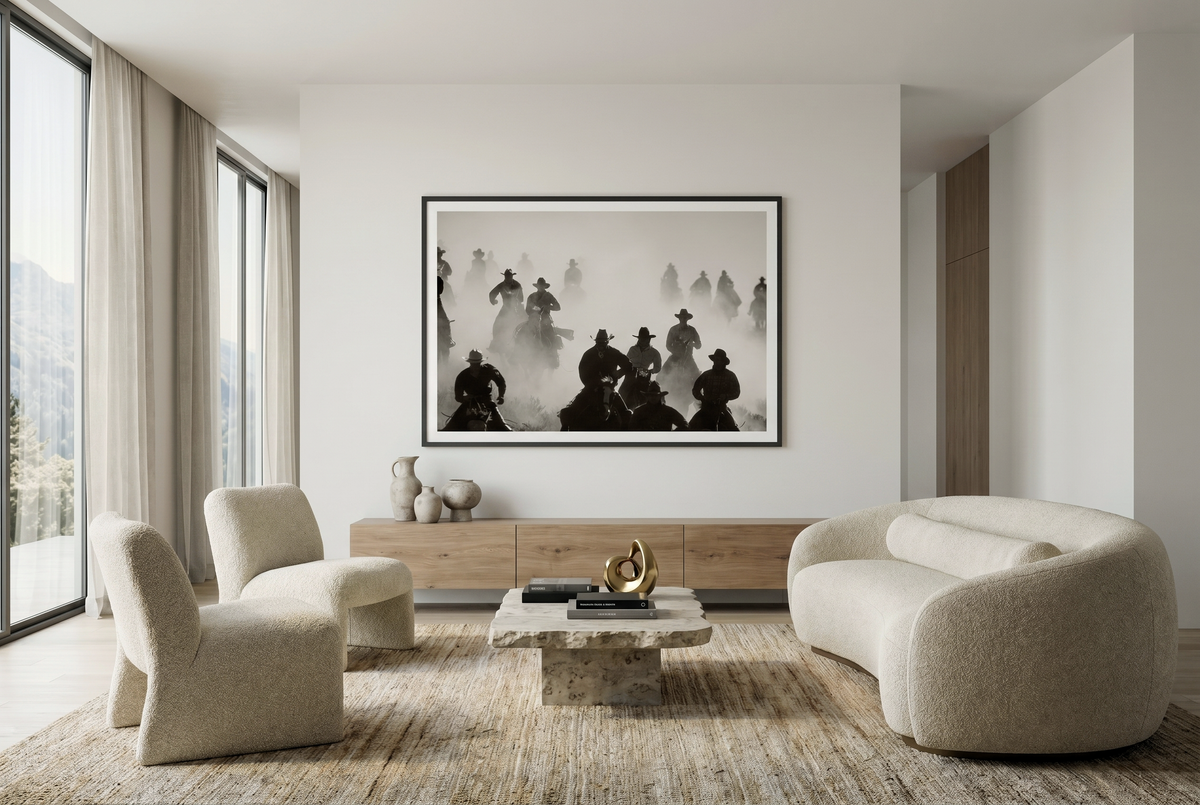 Posse fine art print in a black frame above a wood credenza in a living room, by Jules Frazier