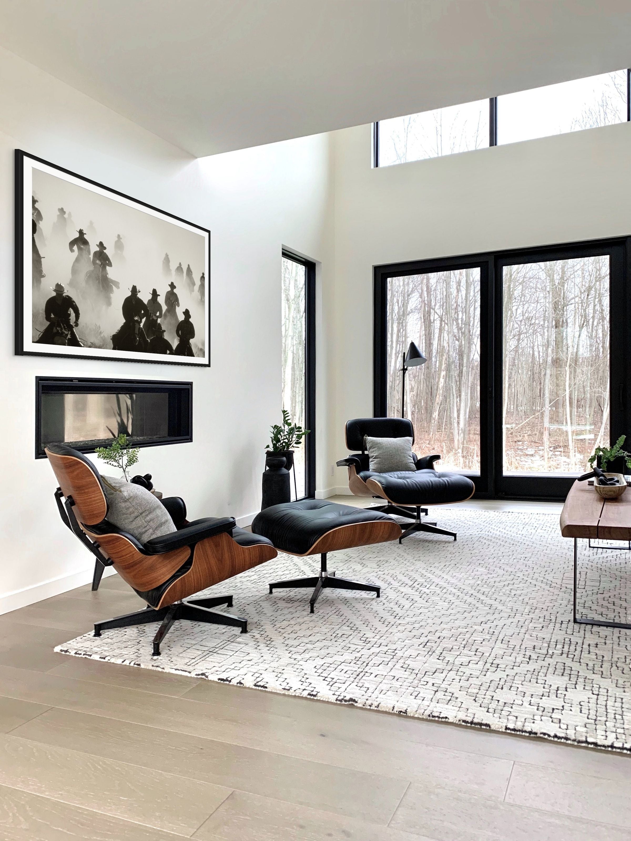 Modern living room with a brown lounge chair, ottoman, and coffee table.