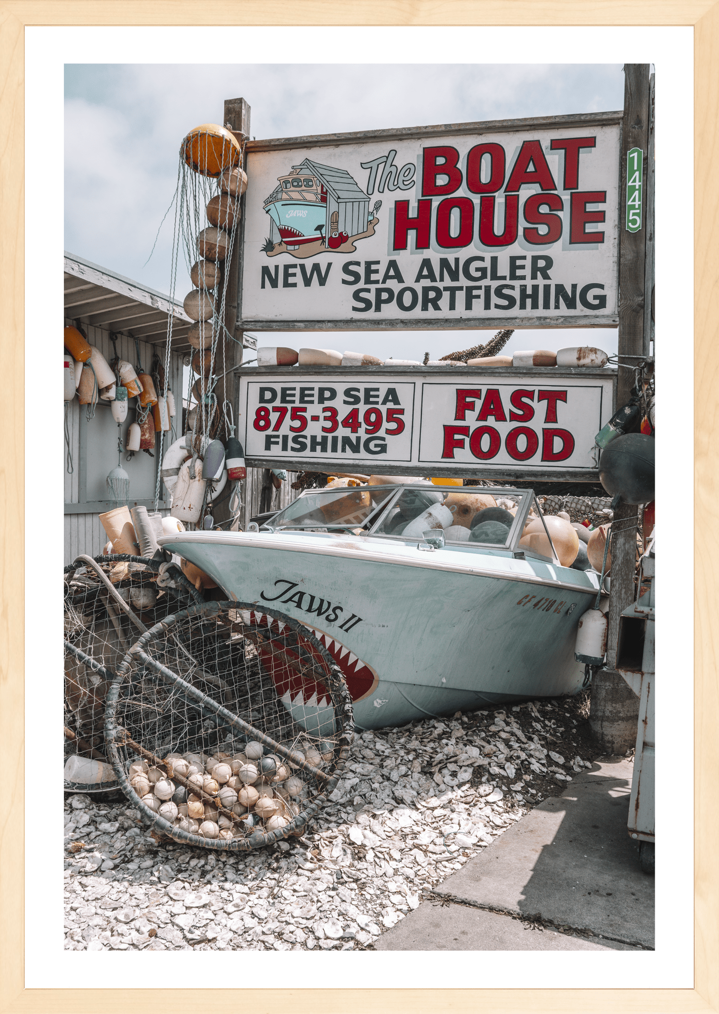 Coastal classic brimming with vintage memorabilia, Boat House, modern fine art print with retro seaside charm. Natural frame.