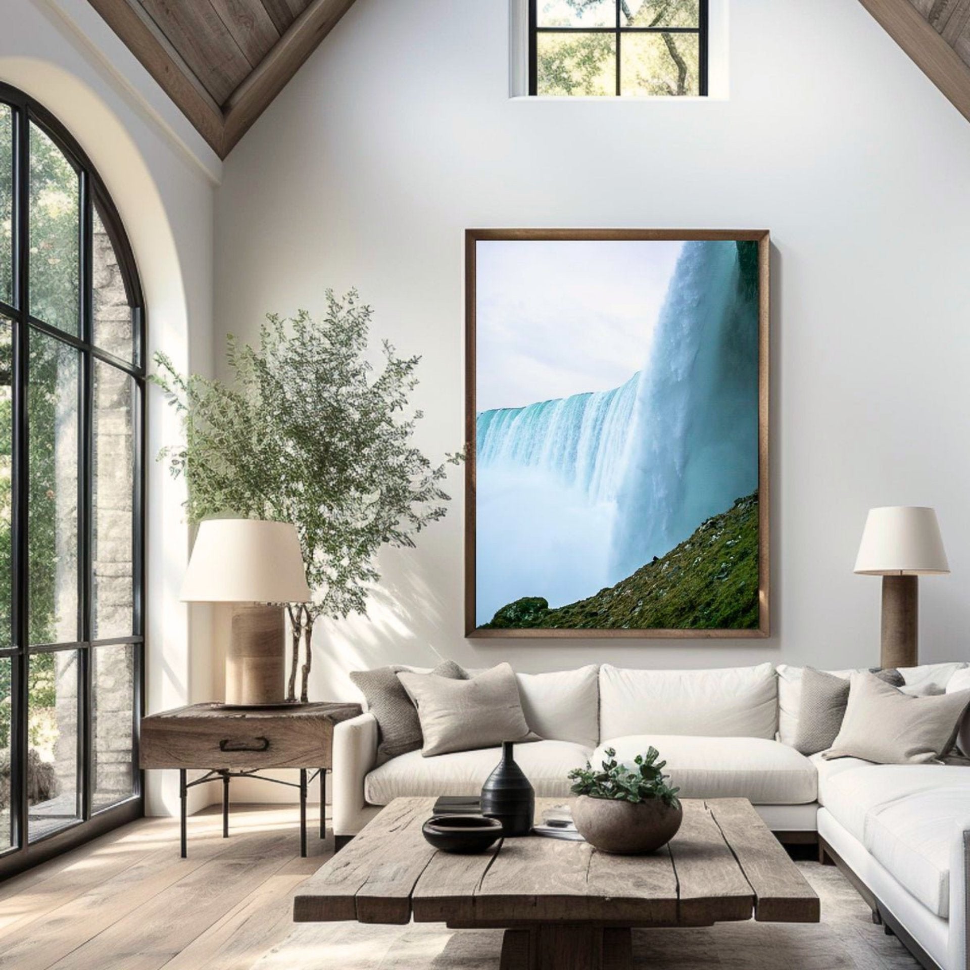 Living room with a large framed picture of a waterfall, white sofa, and wooden coffee table.