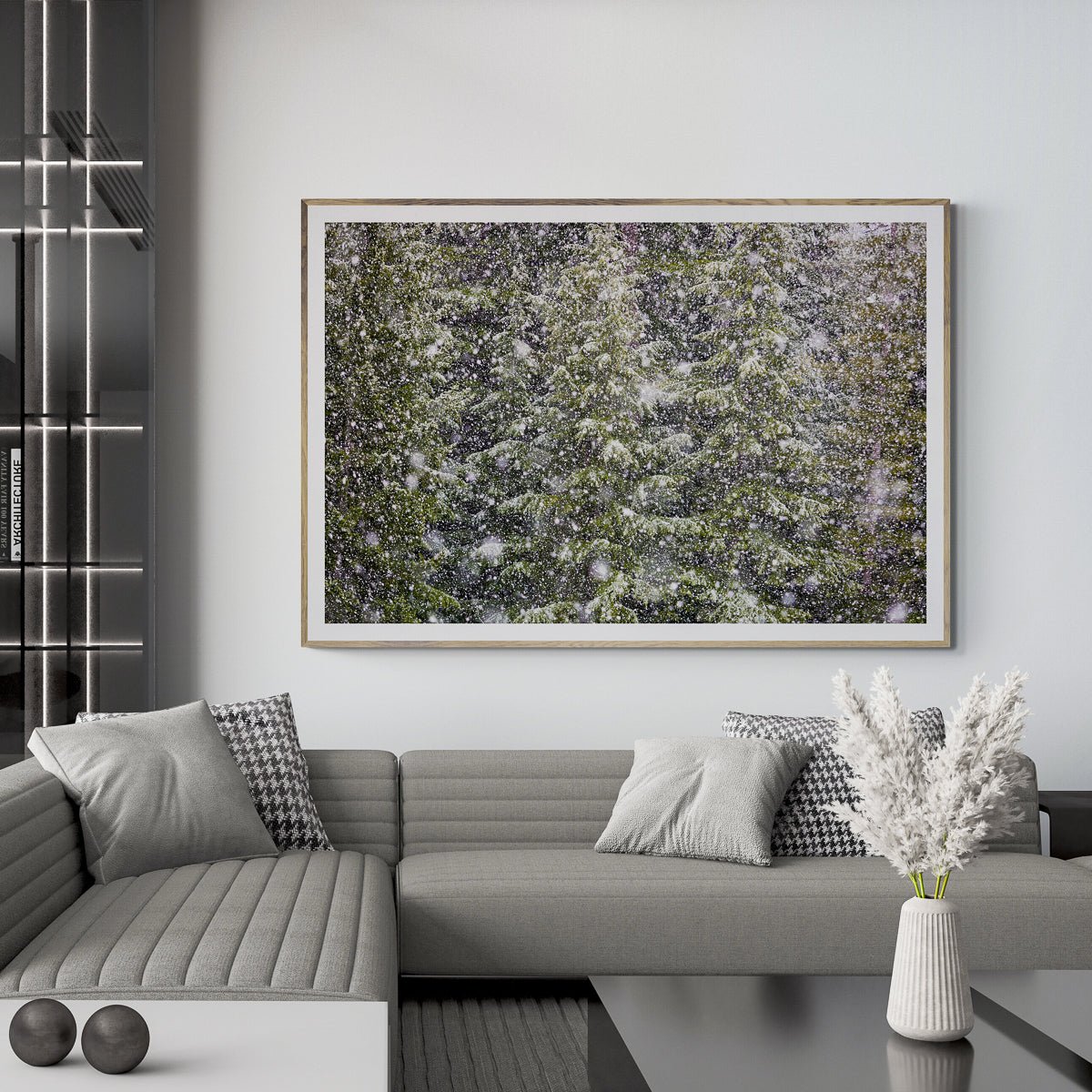 Big Snow No. 1 fine art print in a natural wood frame above a grey sofa, by Jules Frazier