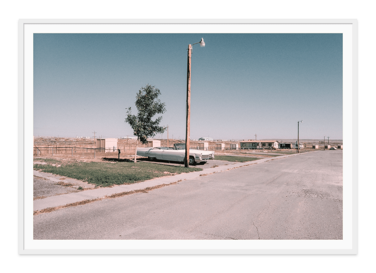 Cadillac No One Home, Rawlins, Wyoming fine art print in a white frame with white mat, by Jules Frazier.